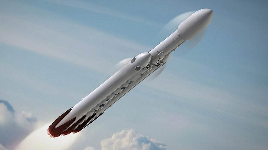Ilustración de un Falcon Heavy, con sus tres núcleos, en ascenso sobre las nubes