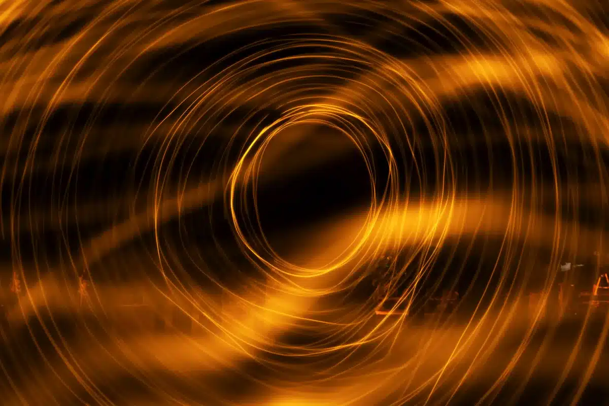Espirales de luz anaranjada que giran alrededor de un centro oscuro