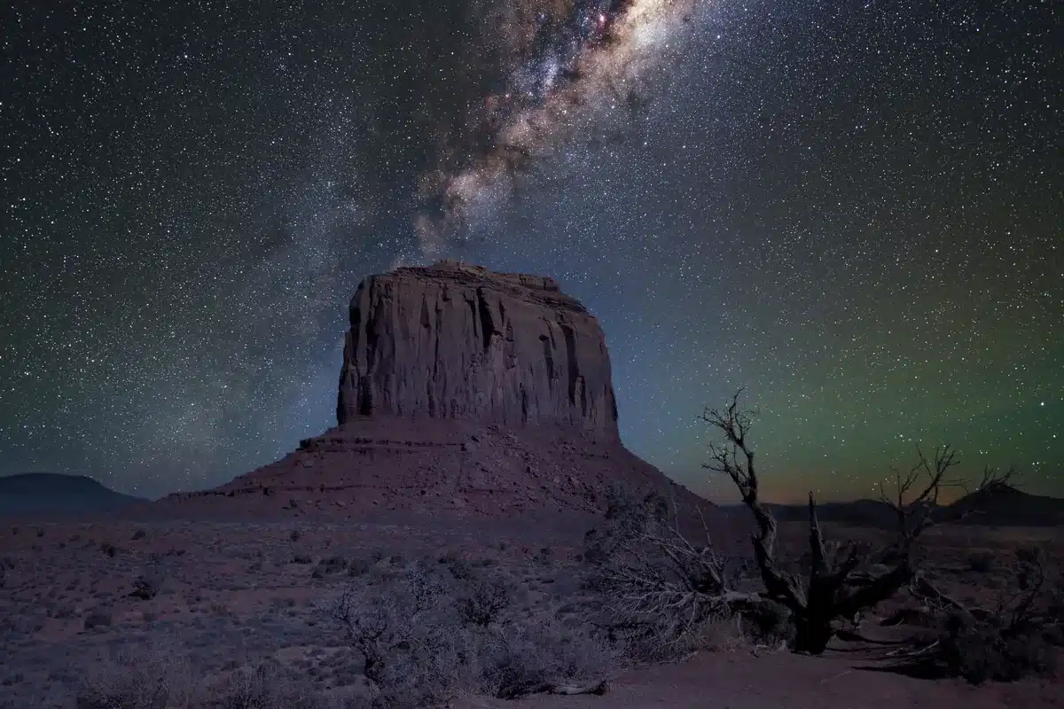 Vía Láctea sobre una formación rocosa en un desierto de noche