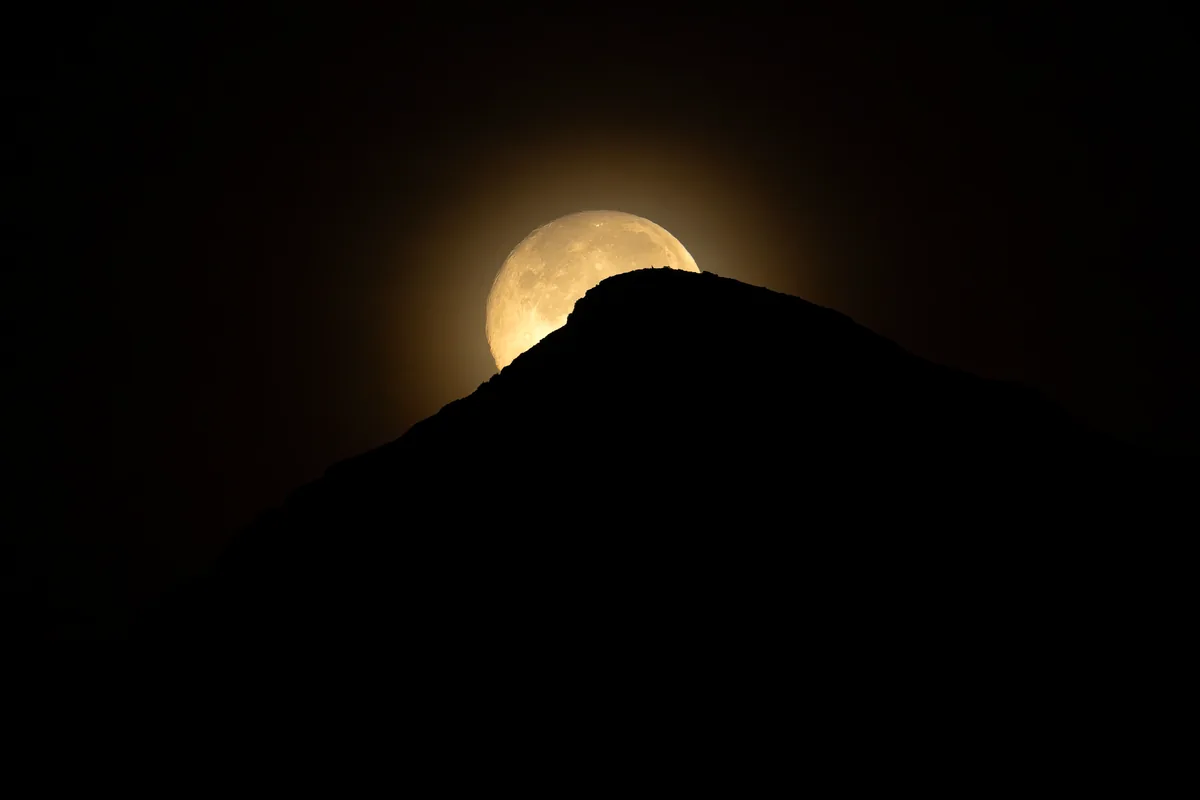 partial solar eclipse desert landscape telescope silhouette no people
